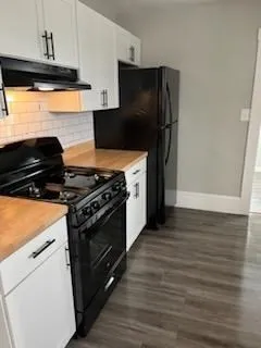 a kitchen with wooden cabinets and a stove top oven