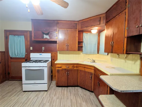a kitchen with a stove a sink and a refrigerator