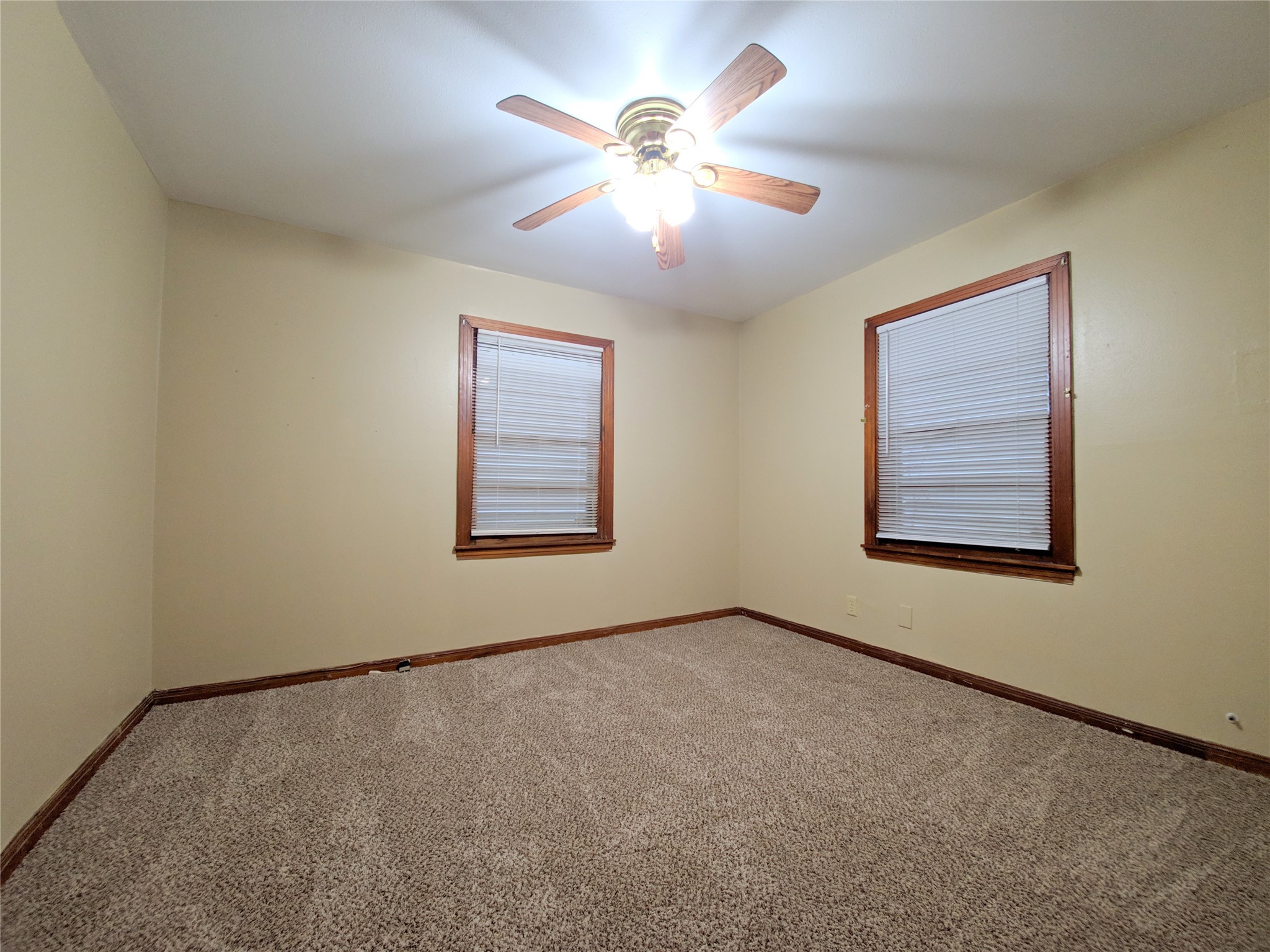 1717 Hawthorne Street La Marque, TX 77568 - Photo 8 of 11 an empty room with windows and fan