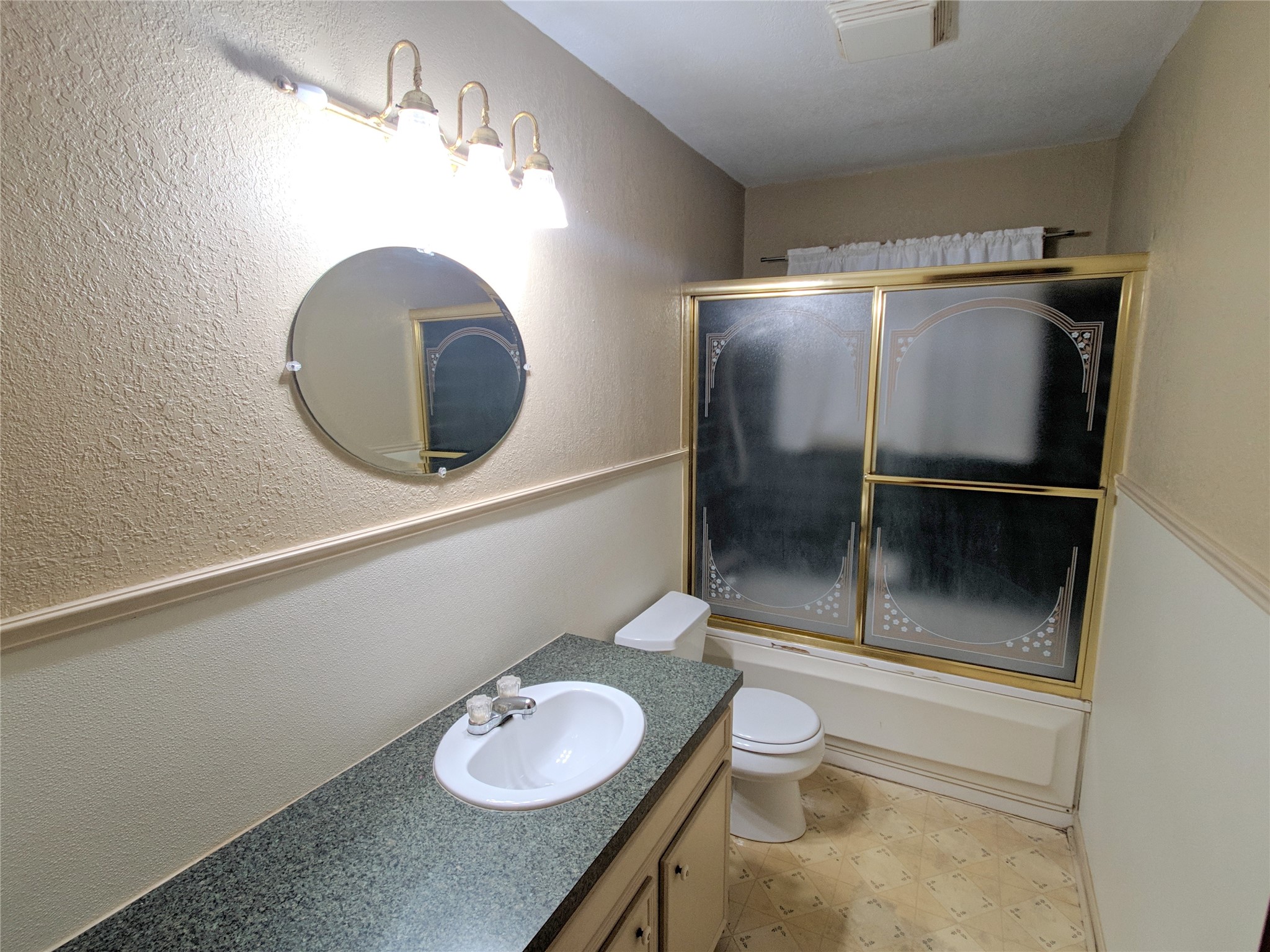 1717 Hawthorne Street La Marque, TX 77568 - Photo 9 of 11 a bathroom with a granite countertop sink a toilet and a mirror
