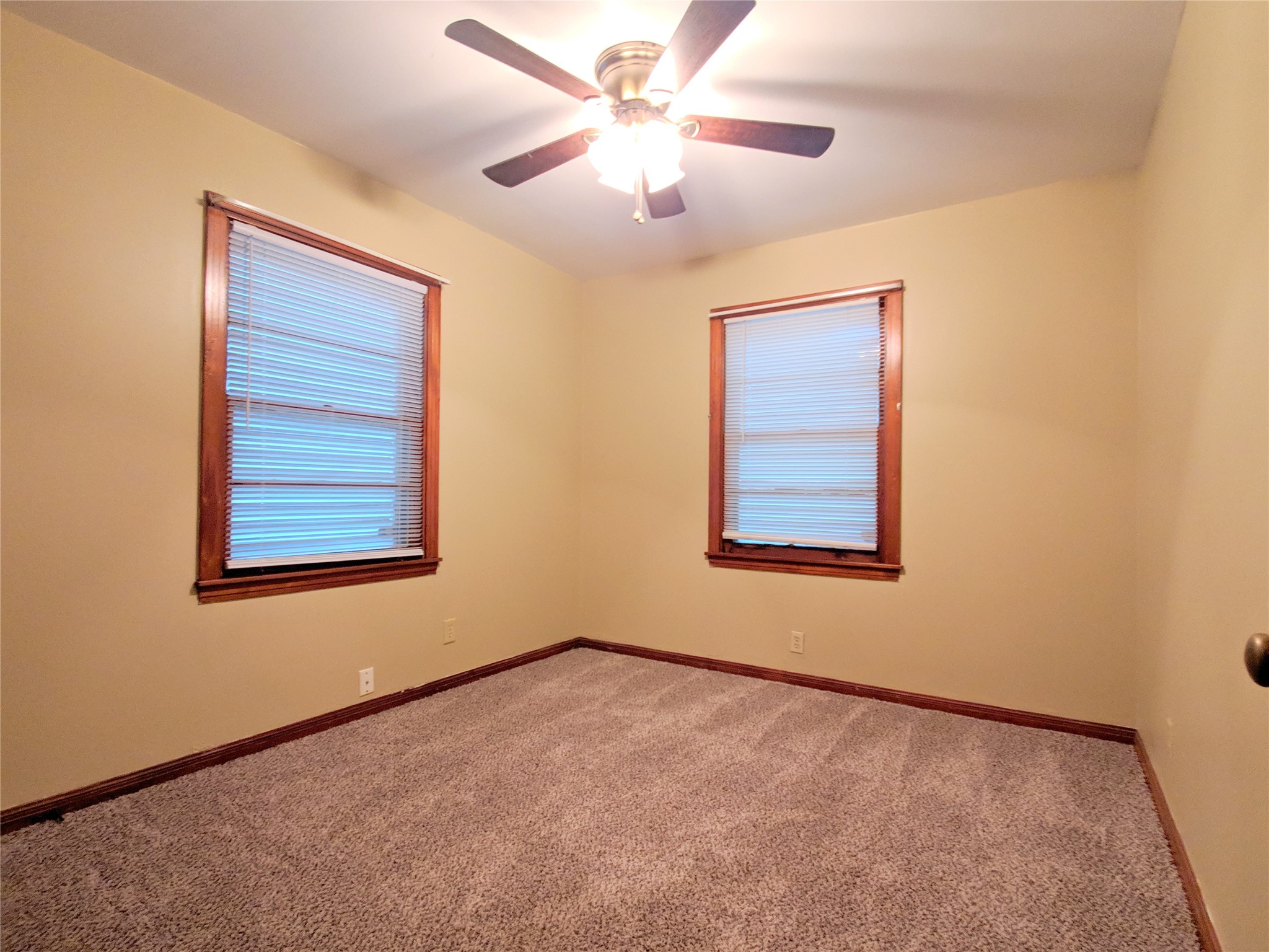 1717 Hawthorne Street La Marque, TX 77568 - Photo 10 of 11 an empty room with a window and a ceiling fan