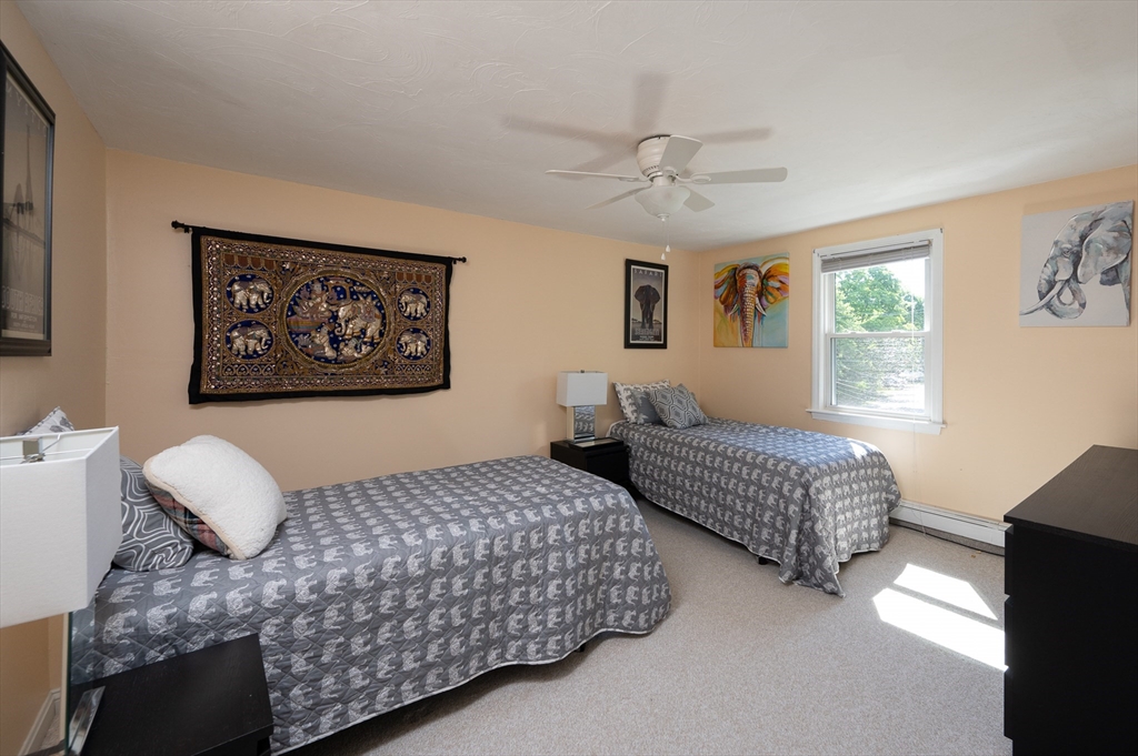 29 Wituwamat Road Weymouth, MA 02191 - Photo 26 of 42 a bedroom with two beds and a chandelier