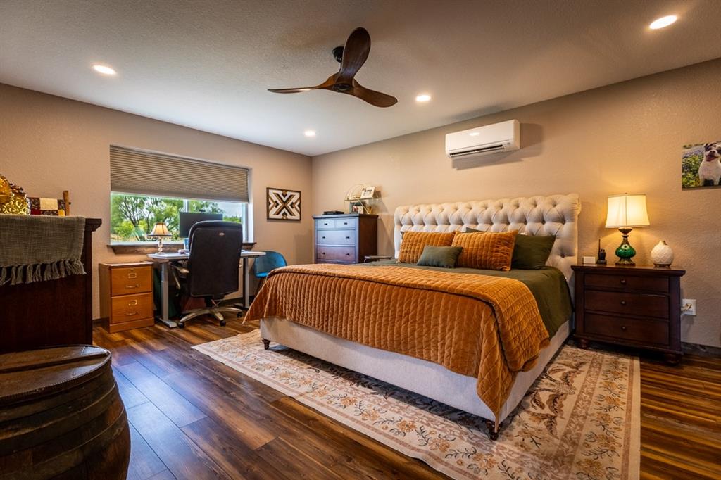 7060 Hells Gate Loop Strawn, TX 76475 - Photo 27 of 40 a bed room with a bed and a chair
