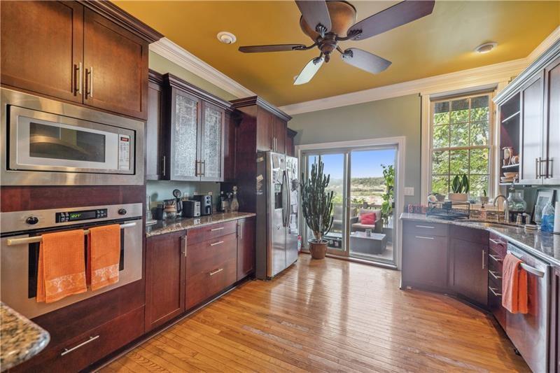 167 Pius Street Pittsburgh, PA 15203 - Photo 11 of 49 a kitchen with stainless steel appliances wooden floors stove and cabinets