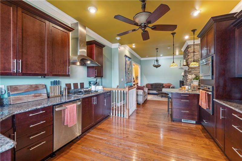 167 Pius Street Pittsburgh, PA 15203 - Photo 14 of 49 a kitchen with stainless steel appliances granite countertop a stove a sink dishwasher and a refrigerator