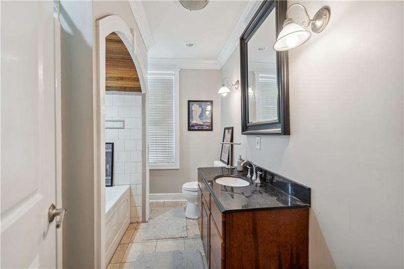 167 Pius Street Pittsburgh, PA 15203 - Photo 29 of 49 a bathroom with a granite countertop sink a mirror and a shower