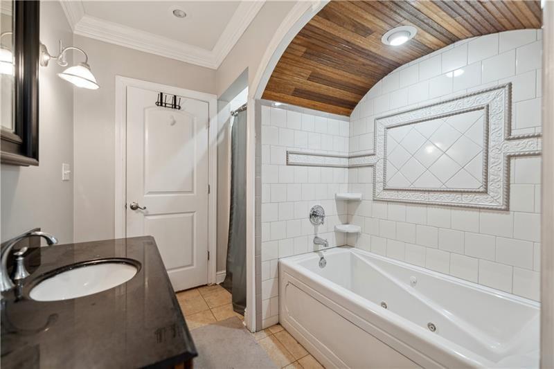 167 Pius Street Pittsburgh, PA 15203 - Photo 30 of 49 a bathroom with a tub a sink and a mirror