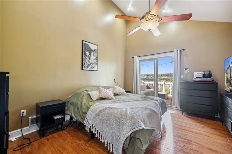 167 Pius Street Pittsburgh, PA 15203 - Photo 31 of 49 a bedroom with a bed and wooden floor
