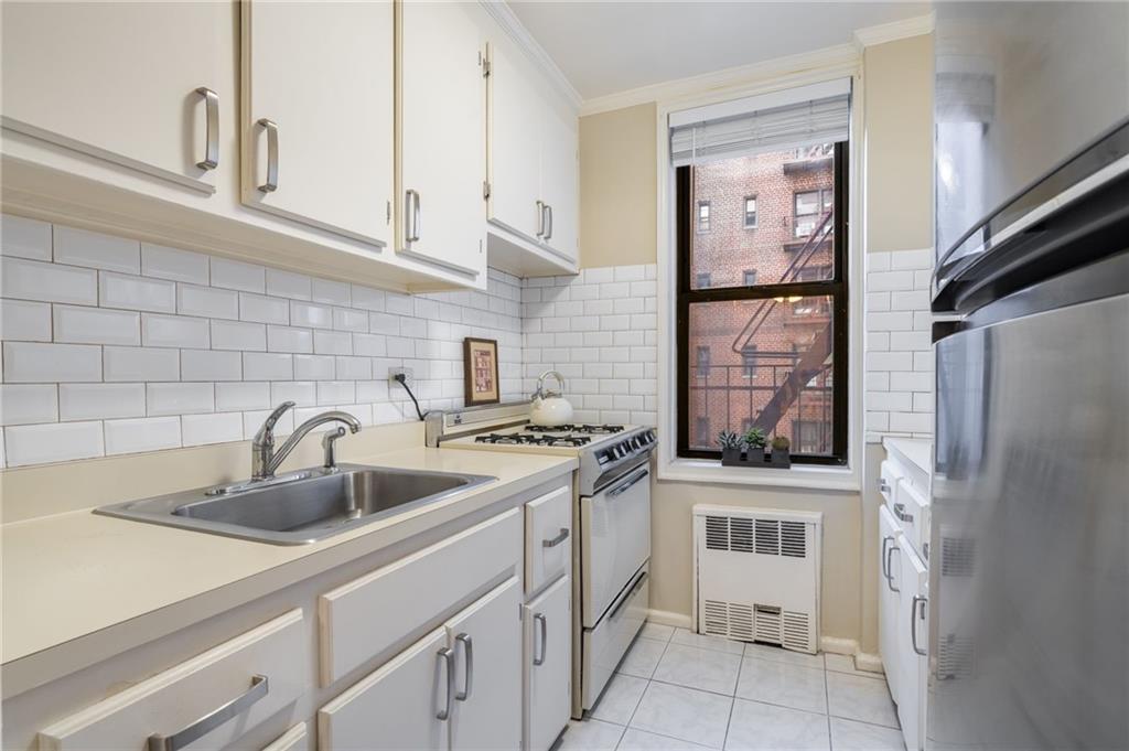 3060 Ocean Avenue, Unit 2L Brooklyn, NY 11235 - Photo 6 of 13 a kitchen with stainless steel appliances granite countertop a sink stove and refrigerator