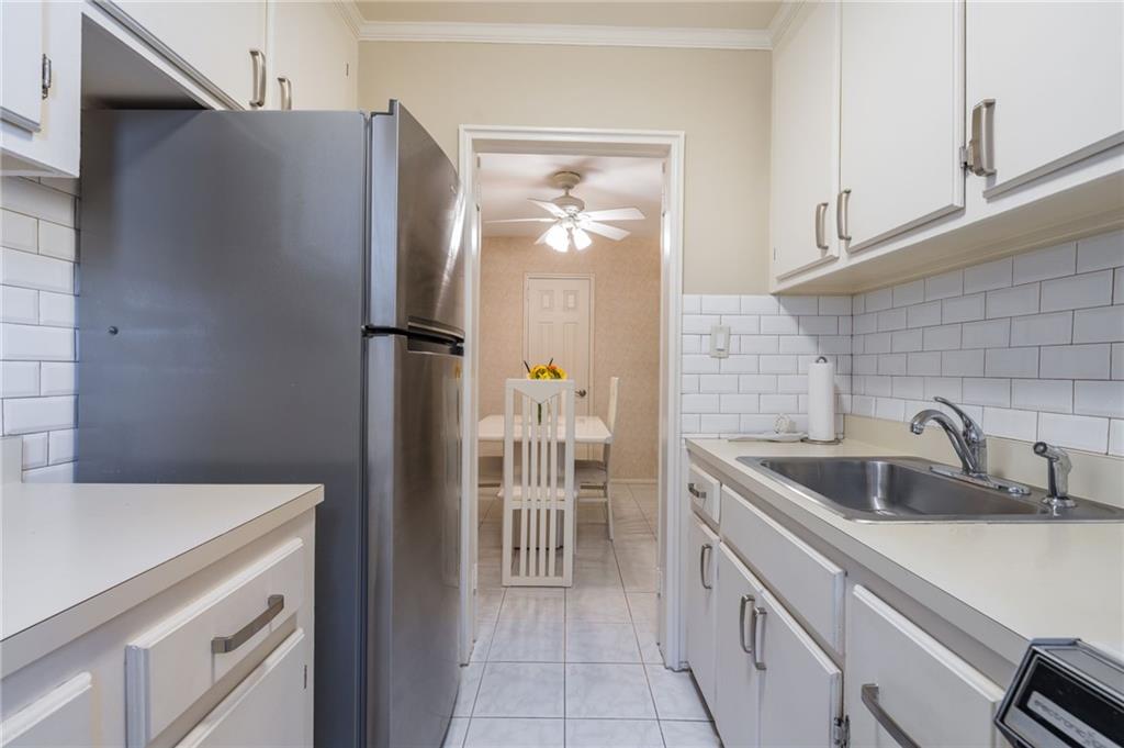 3060 Ocean Avenue, Unit 2L Brooklyn, NY 11235 - Photo 7 of 13 a kitchen with a refrigerator and a sink