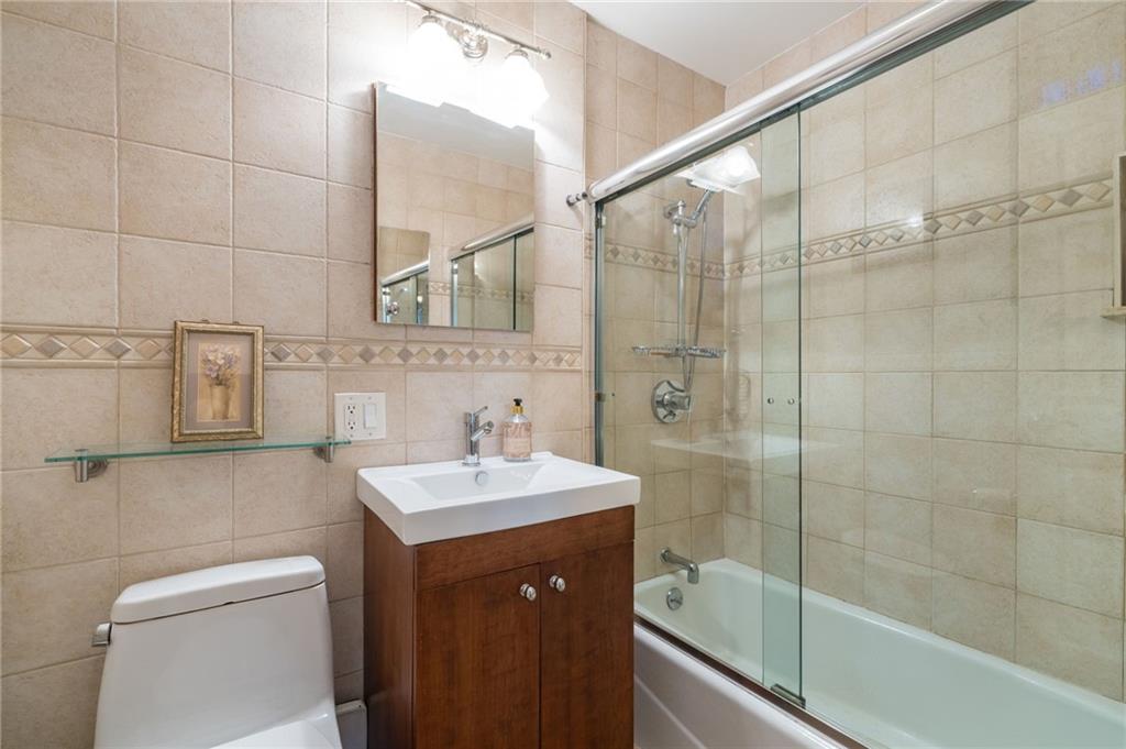 3060 Ocean Avenue, Unit 2L Brooklyn, NY 11235 - Photo 8 of 13 a bathroom with a sink a toilet and shower