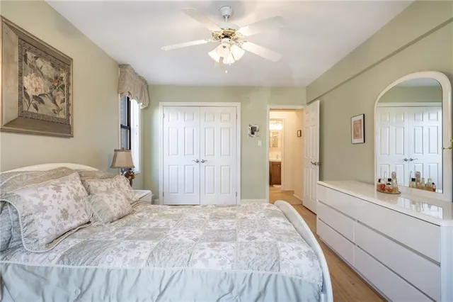 a spacious bedroom with a bed and a chandelier