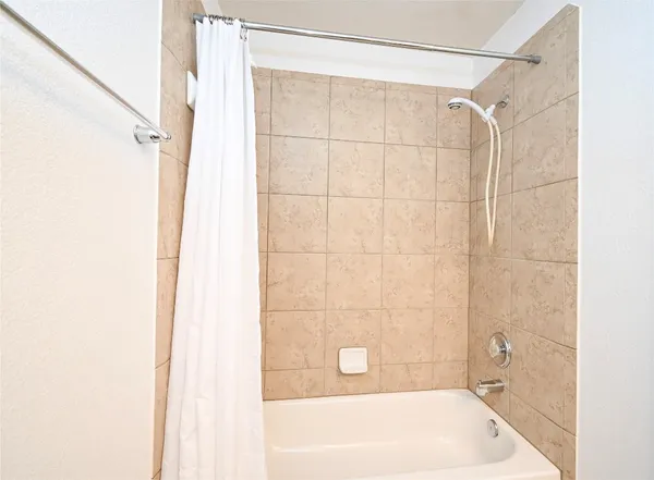 a bathroom with a shower and a tub
