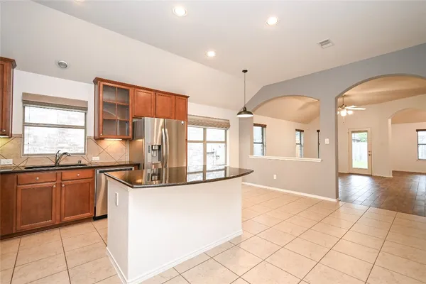 a kitchen with stainless steel appliances granite countertop a sink and cabinets