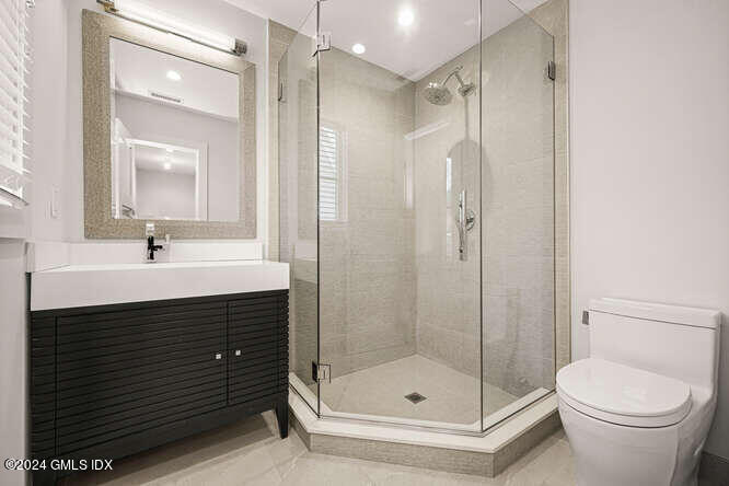 63 Valleywood Road Cos Cob, CT 06807 - Photo 25 of 34 a bathroom with a sink shower and a toilet