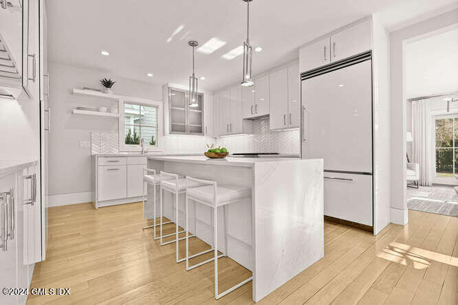 63 Valleywood Road Cos Cob, CT 06807 - Photo 8 of 34 a kitchen with stainless steel appliances a refrigerator a sink dishwasher a stove and white cabinets with wooden floor