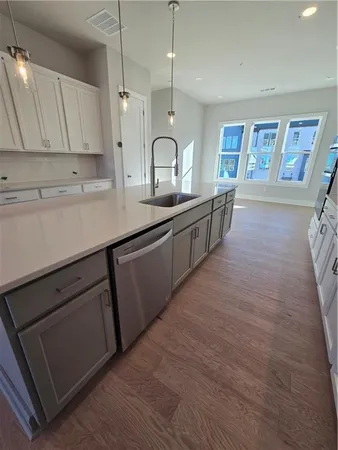 a kitchen with stainless steel appliances granite countertop a sink stove and cabinets