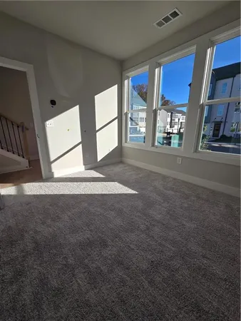 a view of a big room with windows and cabinet