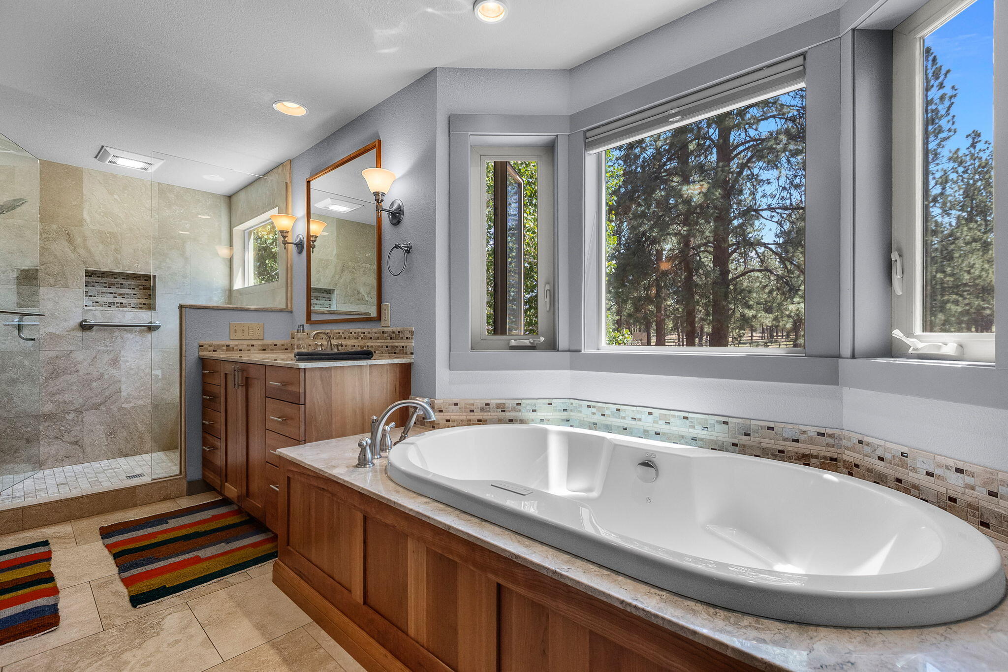 60210 East Ridgeview Drive Bend, OR 97702 - Photo 23 of 55 a bathroom with a tub sink and mirror