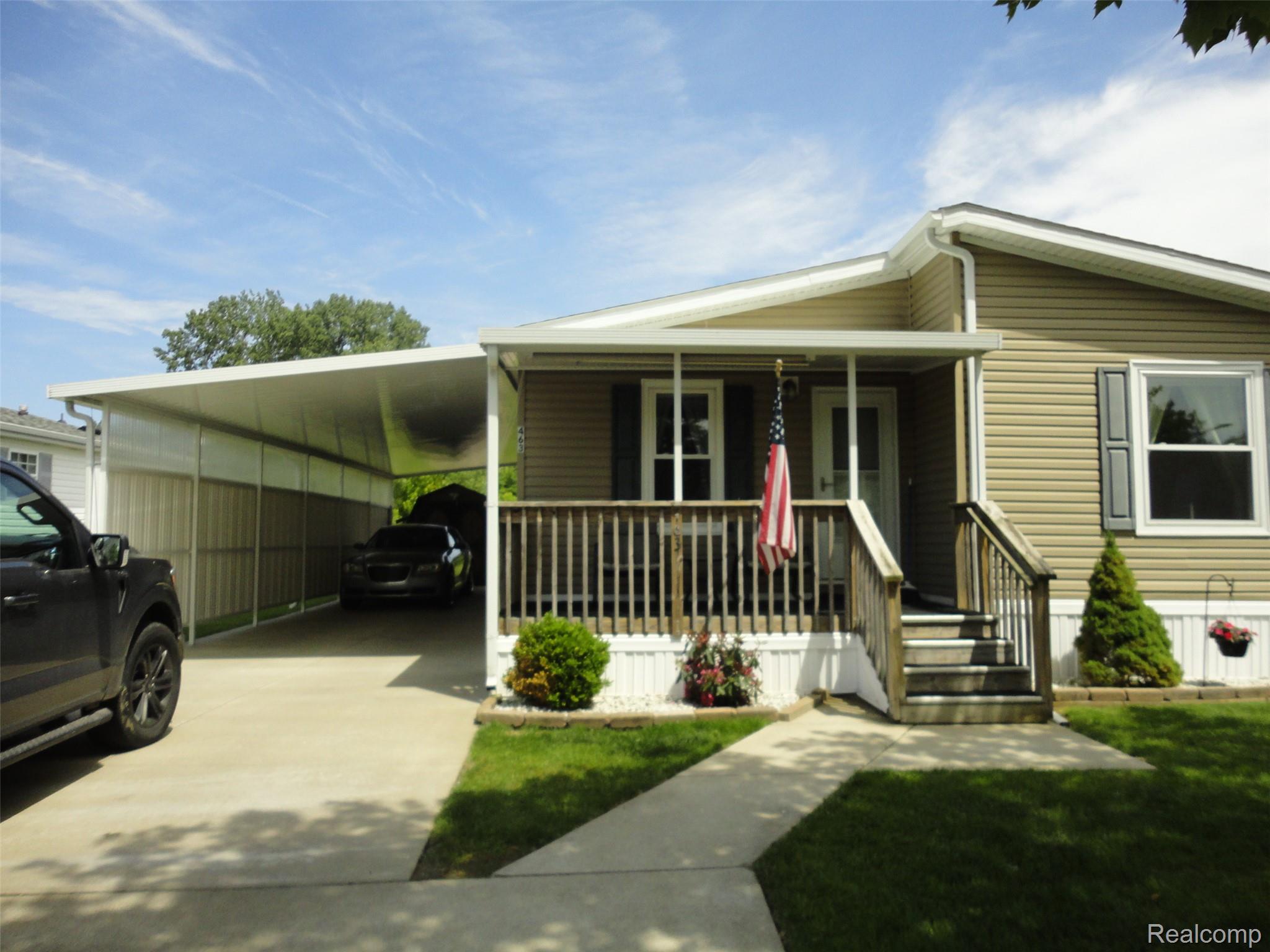463 Edinborough Temperance, MI 48182 - Photo 13 of 23 Siding exterior with a covered front porch featuring wood railings and steps
