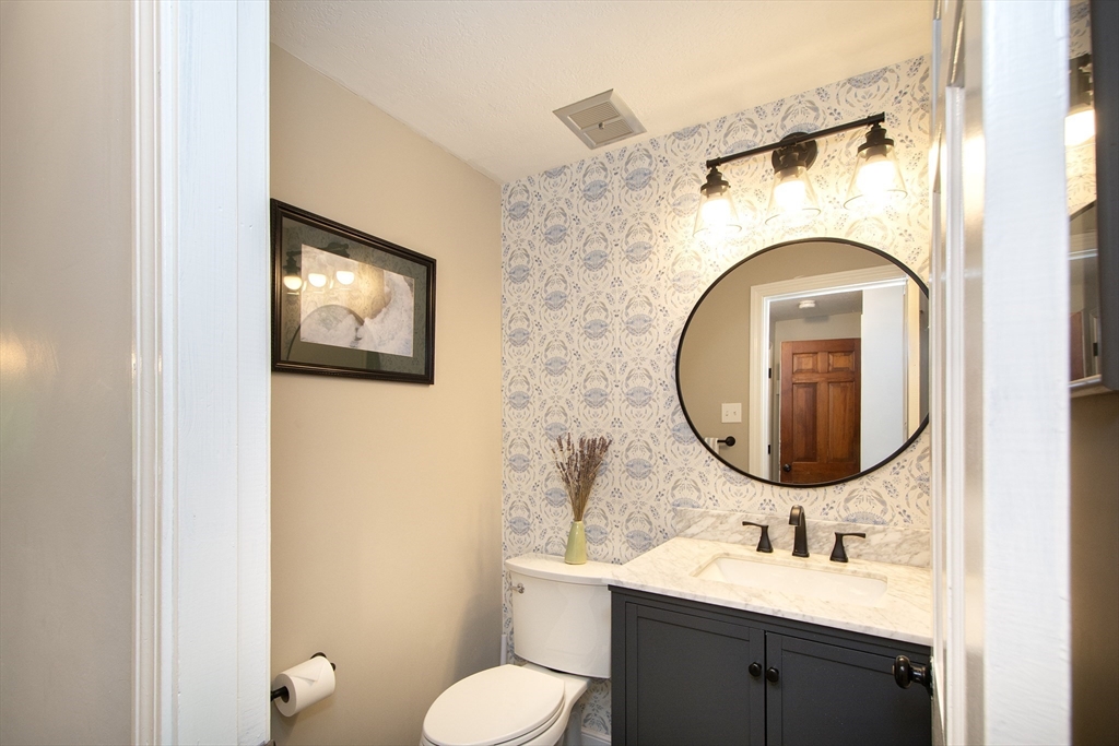 26 Old Coach Road Cohasset, MA 02025 - Photo 11 of 33 a bathroom with a toilet sink and mirror