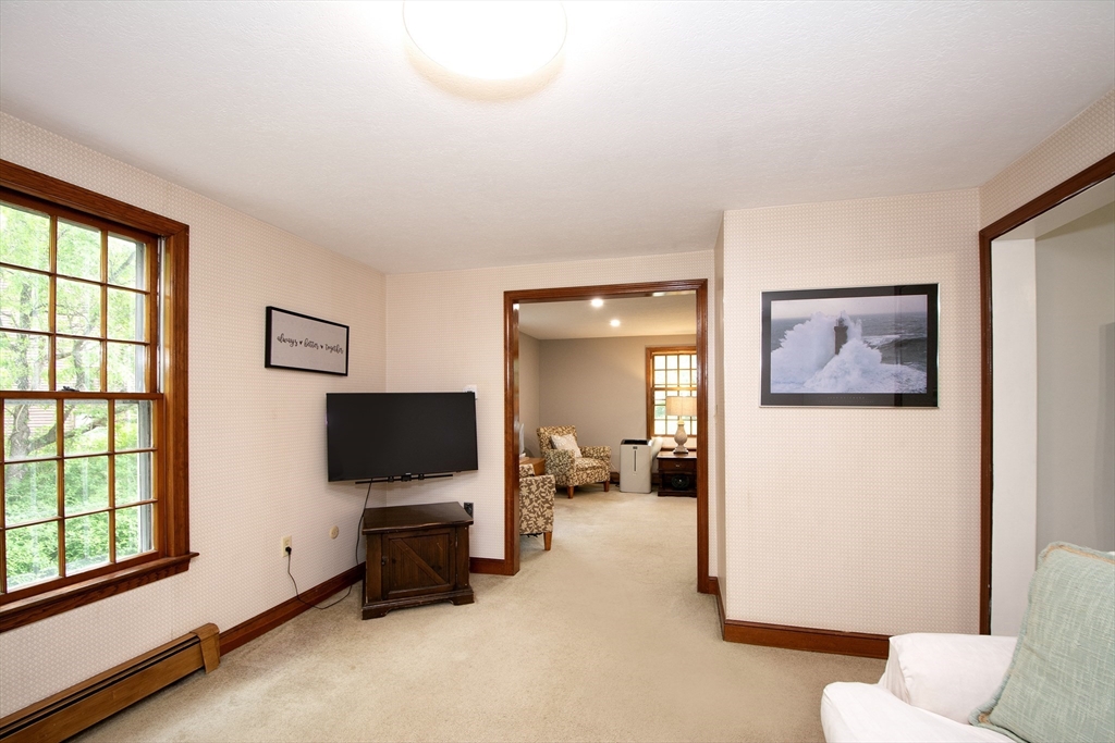 26 Old Coach Road Cohasset, MA 02025 - Photo 17 of 33 a living room with furniture and a flat screen tv