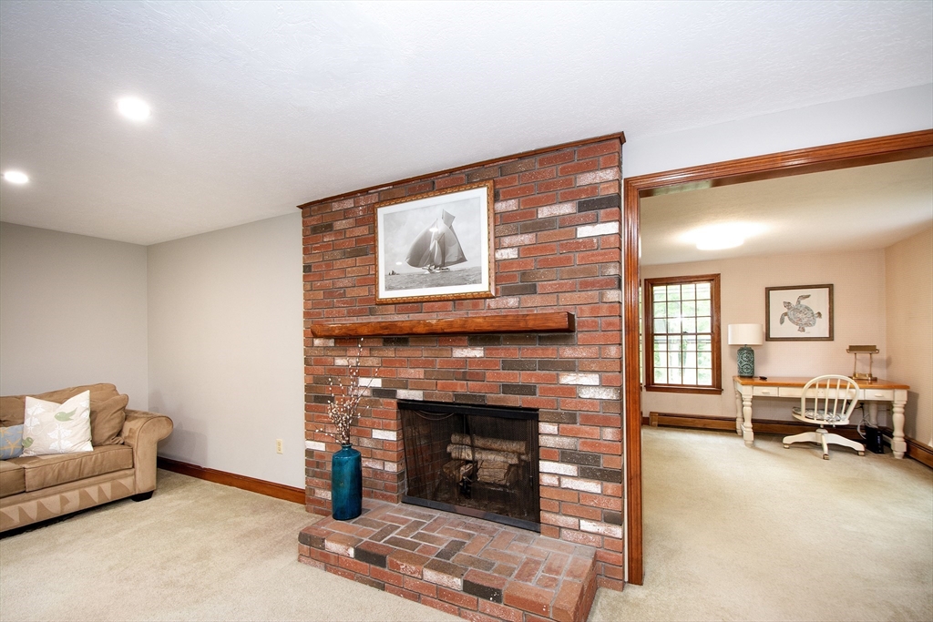 26 Old Coach Road Cohasset, MA 02025 - Photo 18 of 33 a living room with furniture and a fireplace