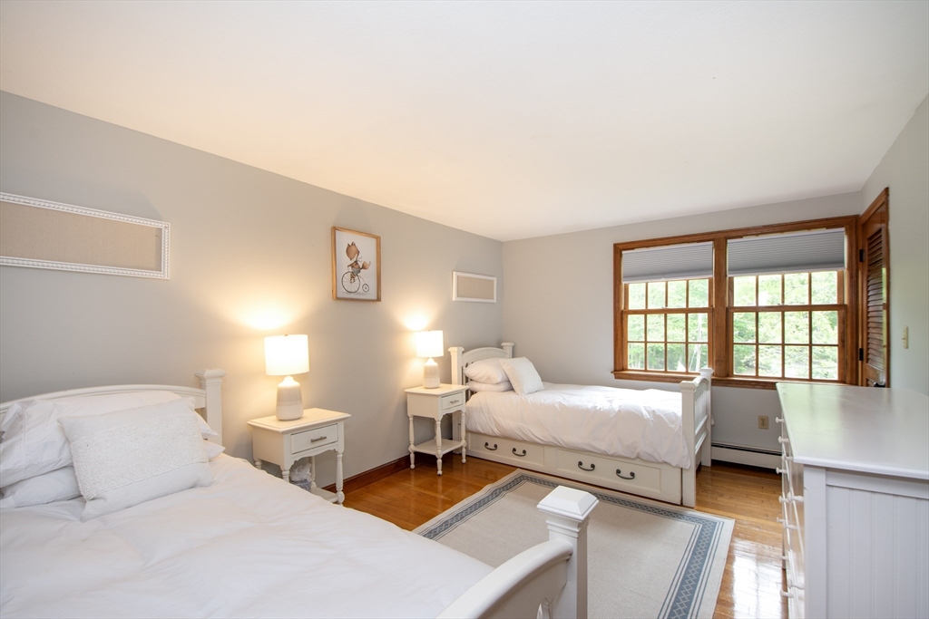 26 Old Coach Road Cohasset, MA 02025 - Photo 19 of 33 a bedroom with a bed and a large window