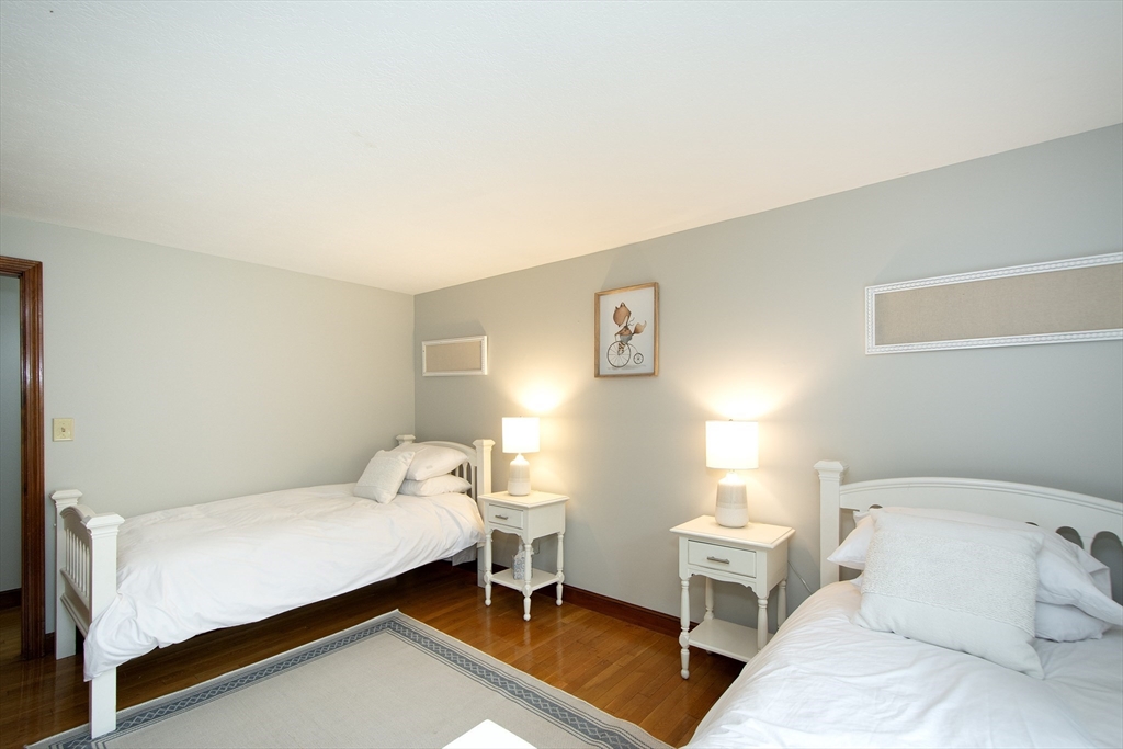 26 Old Coach Road Cohasset, MA 02025 - Photo 20 of 33 a room with a bed and a table in it