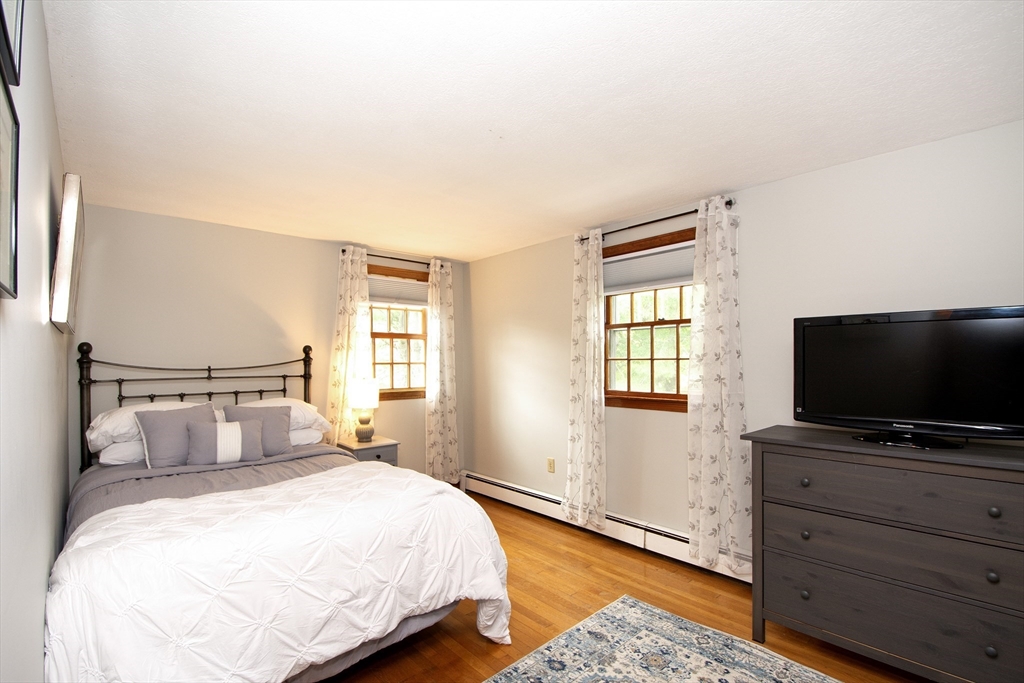 26 Old Coach Road Cohasset, MA 02025 - Photo 21 of 33 a bedroom with a bed and a flat screen tv