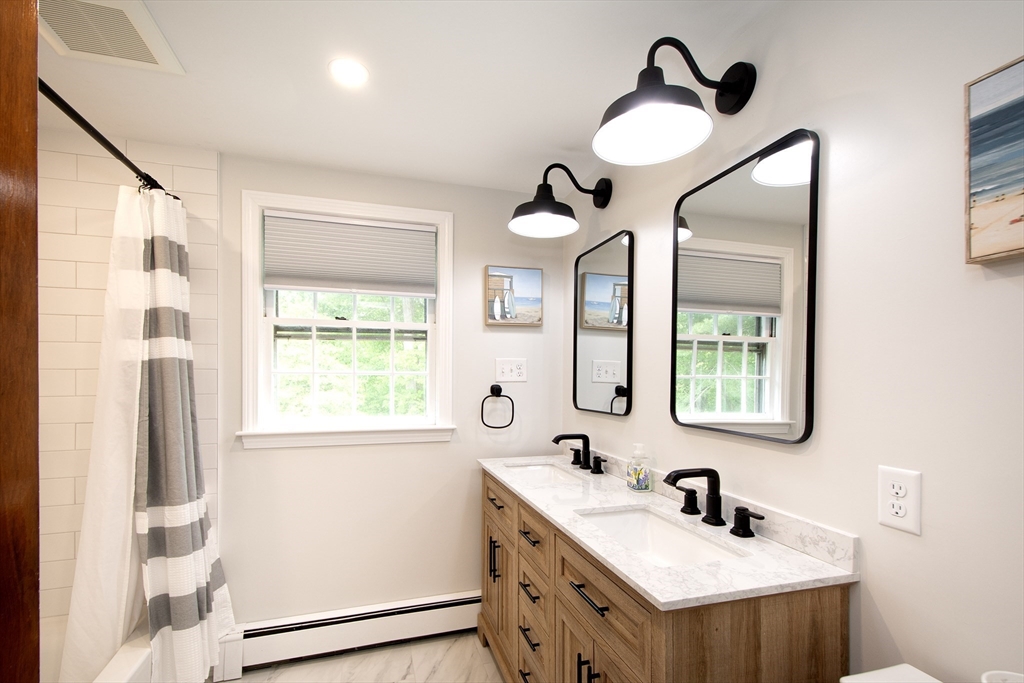 26 Old Coach Road Cohasset, MA 02025 - Photo 23 of 33 a bathroom with a sink and a mirror