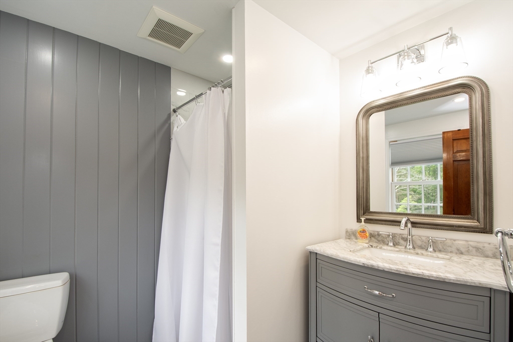 26 Old Coach Road Cohasset, MA 02025 - Photo 26 of 33 a bathroom with a granite countertop sink vanity mirror and toilet