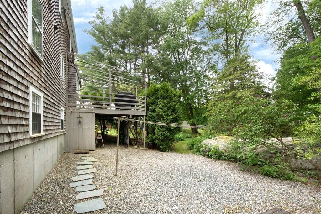 26 Old Coach Road Cohasset, MA 02025 - Photo 30 of 33 a view of a patio with table and chairs with wooden fence and plants
