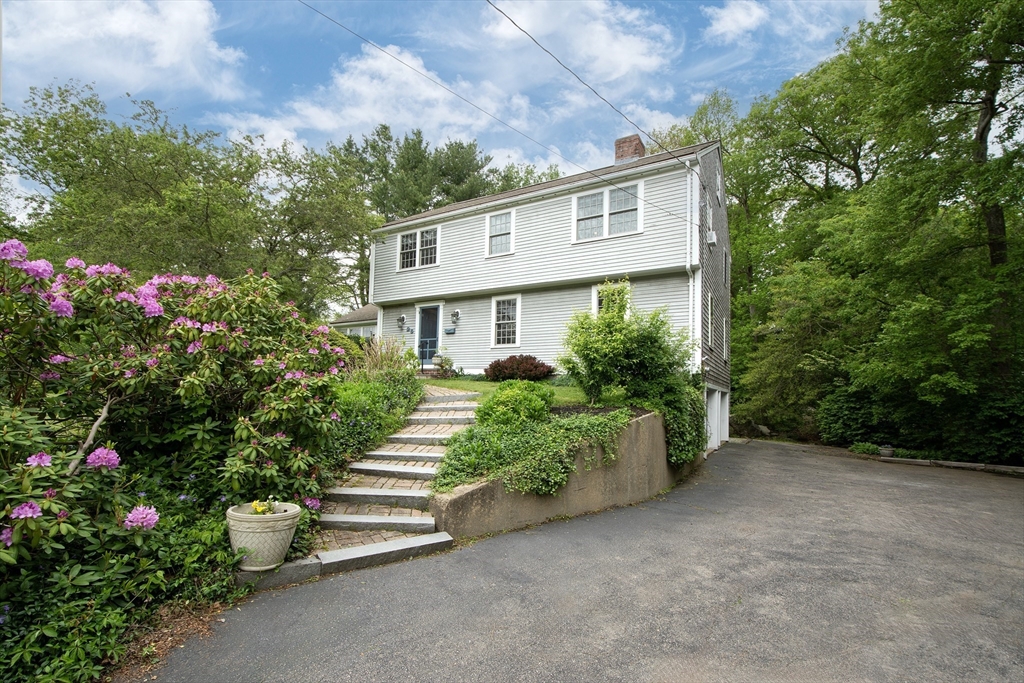 26 Old Coach Road Cohasset, MA 02025 - Photo 32 of 33 a front view of a house with a garden