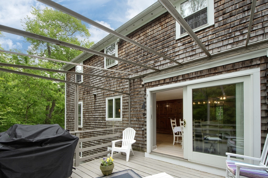 26 Old Coach Road Cohasset, MA 02025 - Photo 7 of 33 a view of a chairs and table in the patio