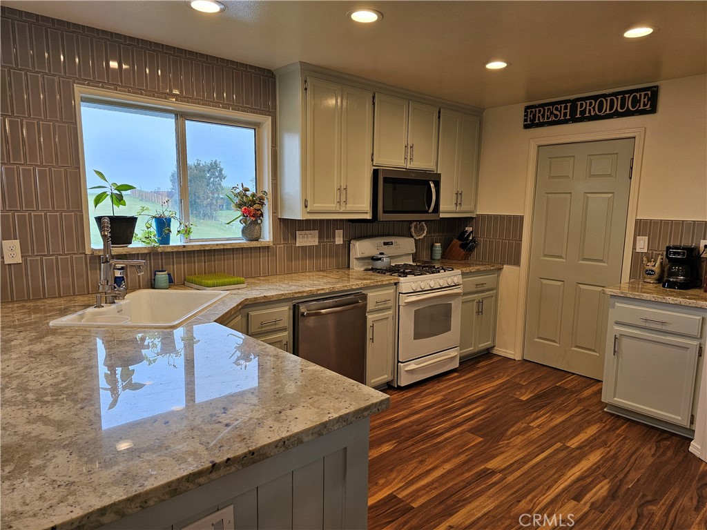 8199 Plane View Place Paso Robles, CA 93446 - Photo 2 of 22 a kitchen with stainless steel appliances granite countertop a sink a stove and a refrigerator