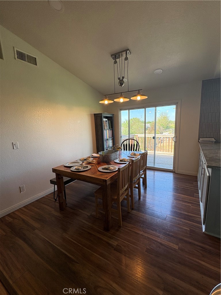 8199 Plane View Place Paso Robles, CA 93446 - Photo 5 of 22 a living room with a table chairs and a wooden floor