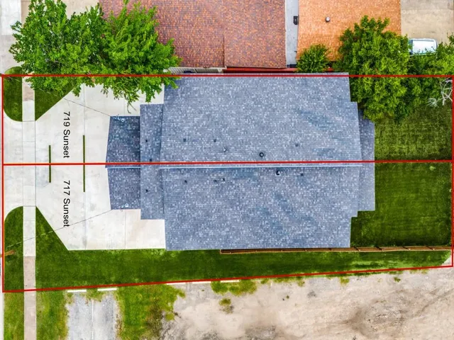 a view of a yard with large trees