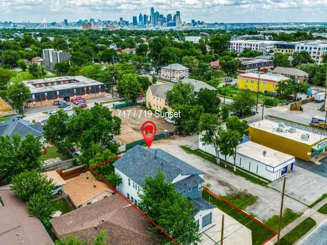an aerial view of a houses with a city street