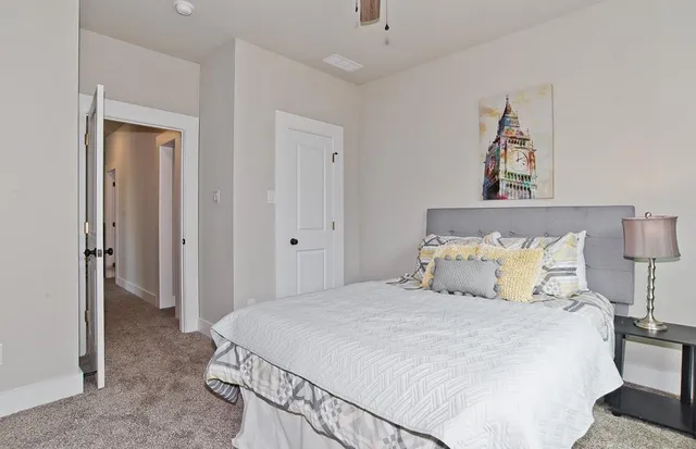 a bedroom with a bed and a lamp