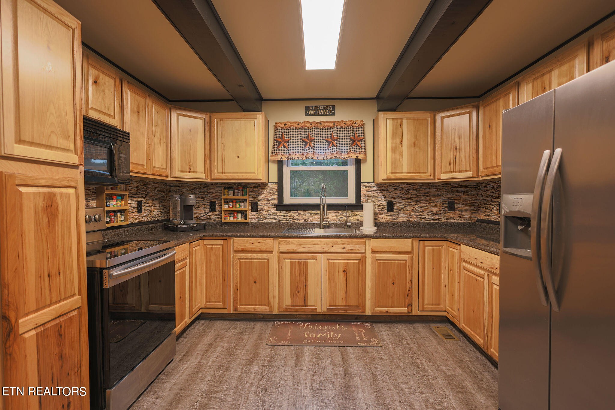 160 Rainbow Lane La Follette, TN 37766 - Photo 14 of 58 a kitchen with stainless steel appliances granite countertop a refrigerator a sink dishwasher a stove and white countertops with wooden floor