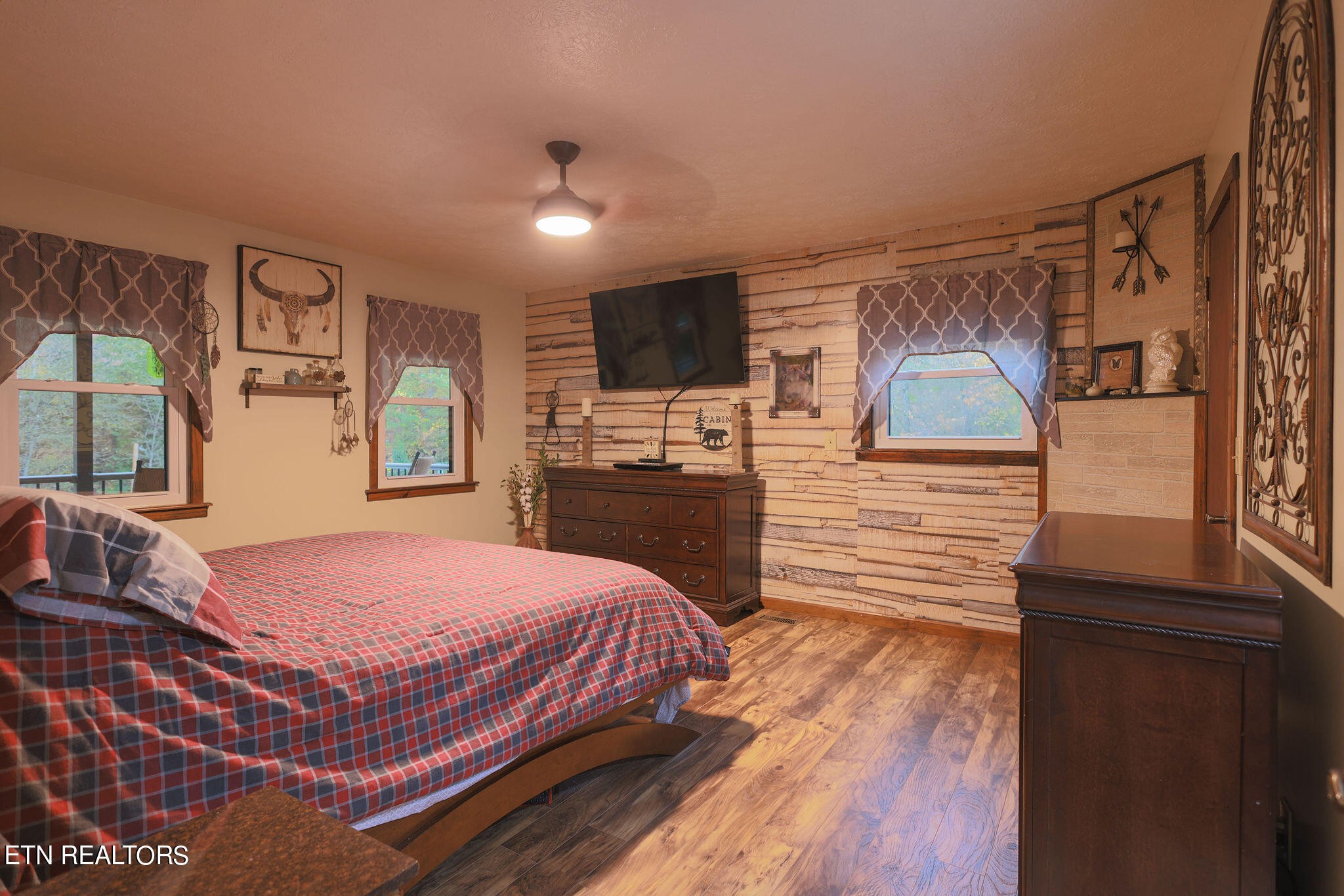 160 Rainbow Lane La Follette, TN 37766 - Photo 19 of 58 a spacious bedroom with a bed and a dresser with wooden floor