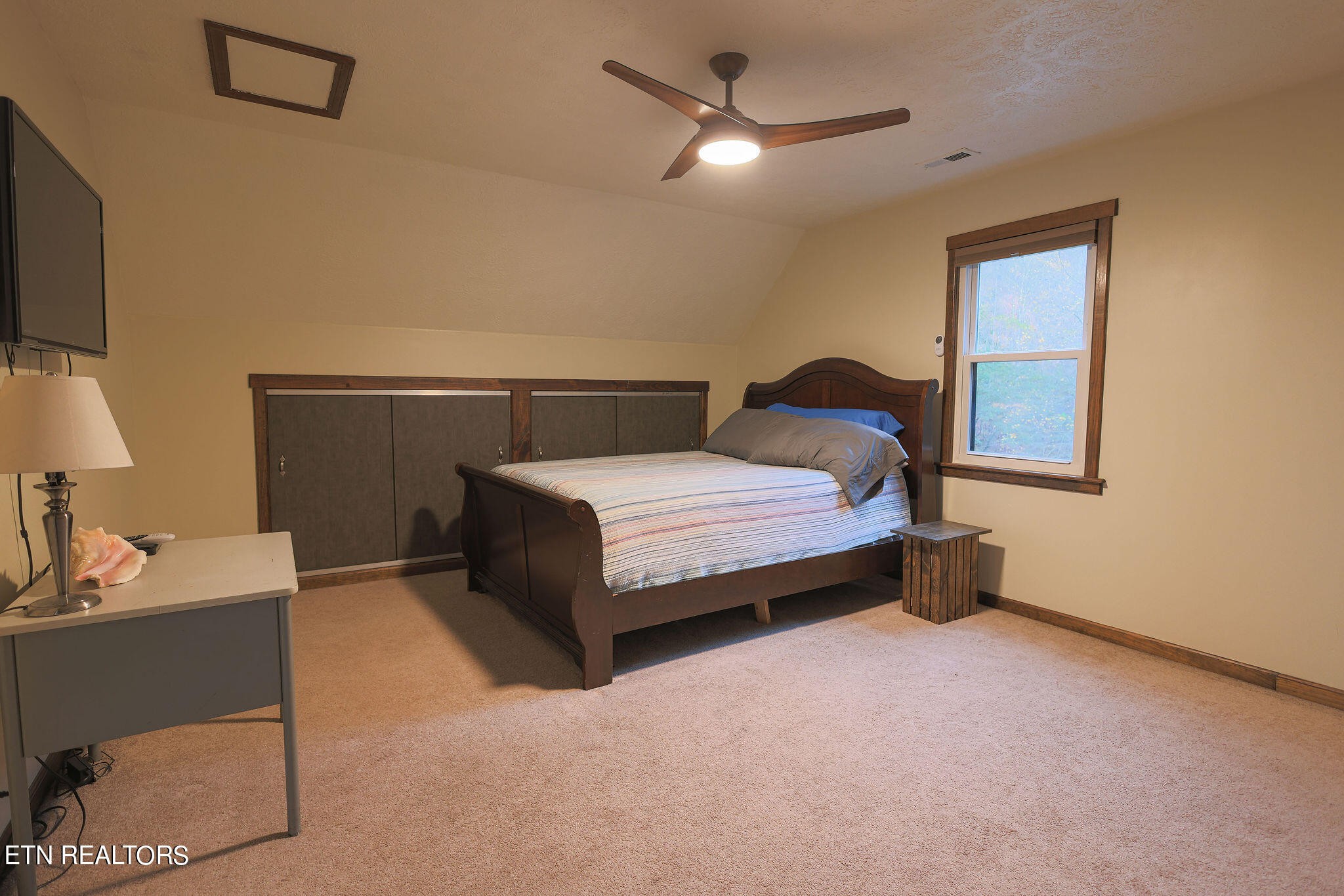 160 Rainbow Lane La Follette, TN 37766 - Photo 38 of 58 a bedroom with a bed and a flat tv screen on dresser
