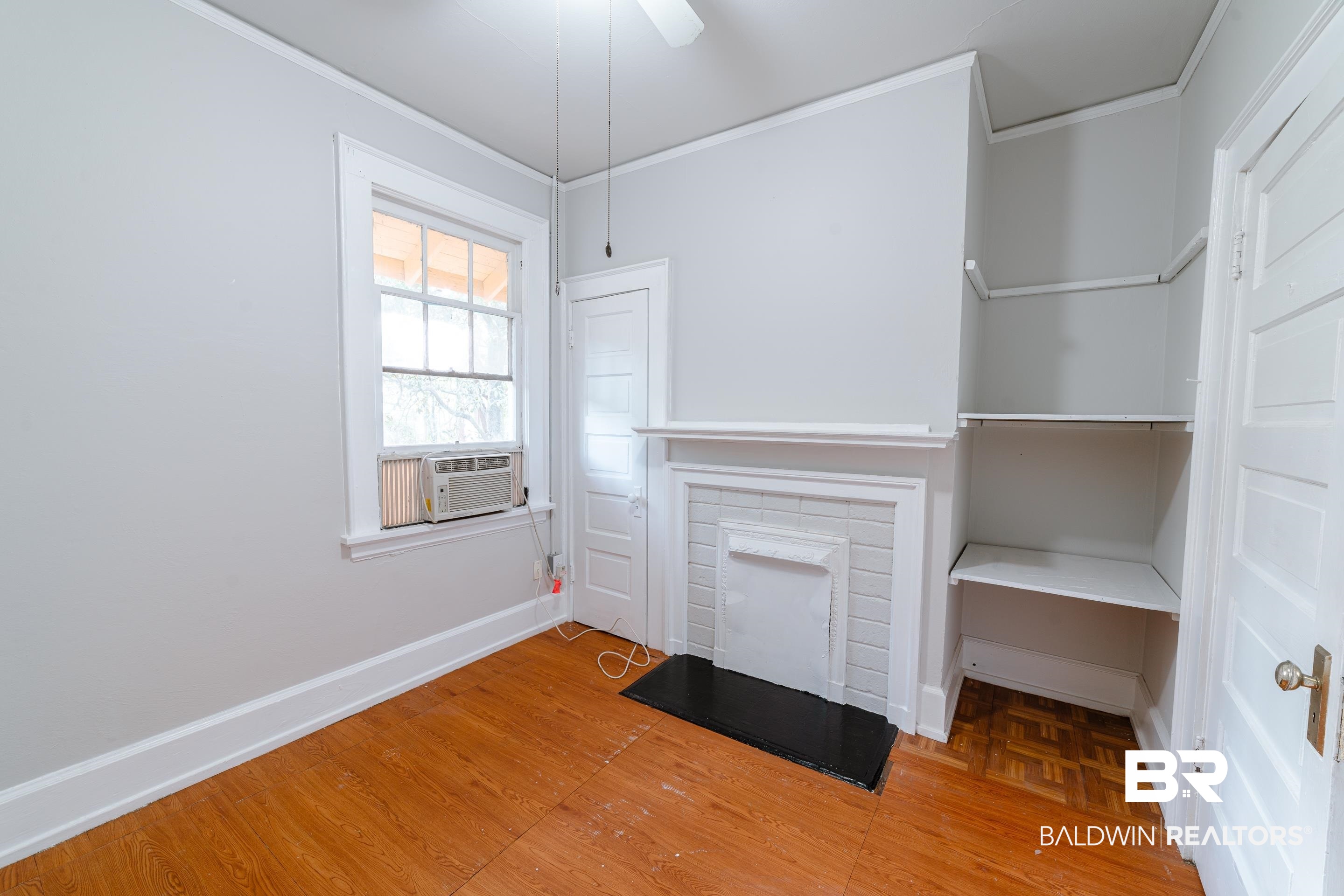 312 1st Street Mobile, AL 36611 - Photo 16 of 29 Unfurnished living room featuring cooling unit, wood-type flooring, and ceiling fan