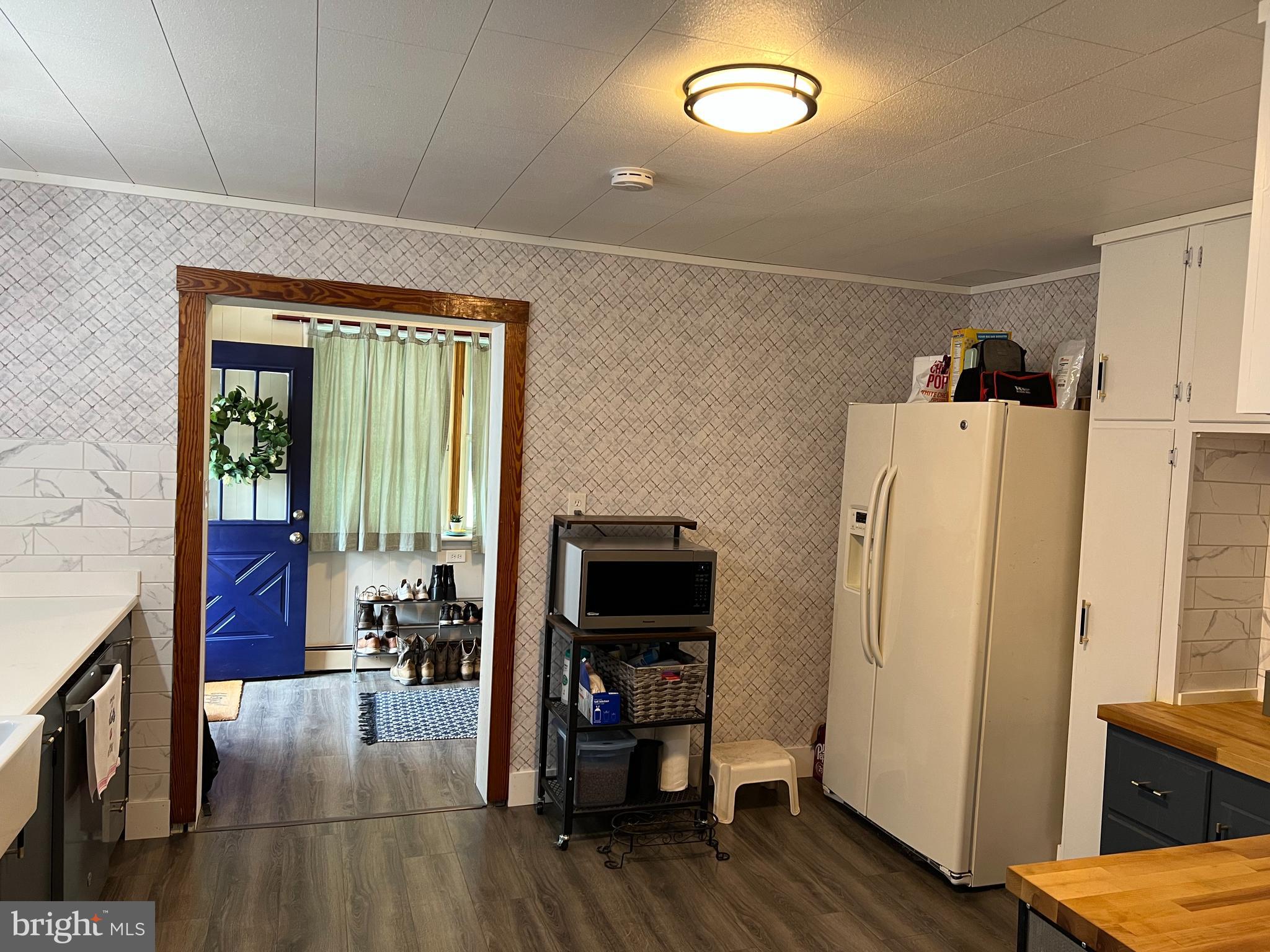 32 Paradise Road Aberdeen, MD 21001 - Photo 8 of 27 a view of a livingroom with furniture and an empty room with wooden floor