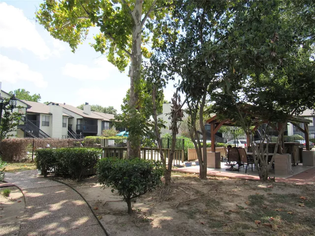 a view of a balcony with chairs and floor to ceiling window