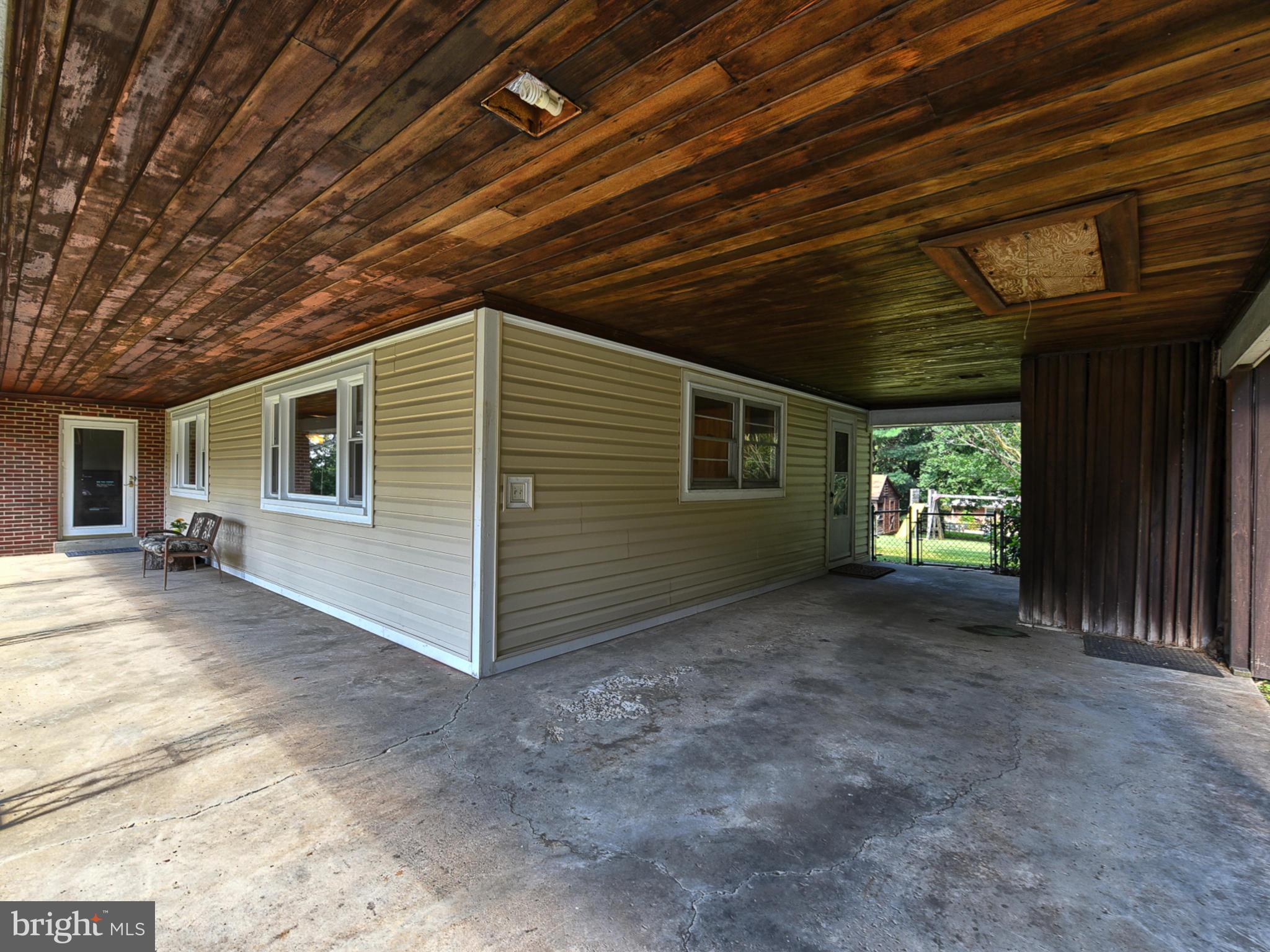 22721 Ridge Road Germantown, MD 20876 - Photo 6 of 41 Covered front porch and carport with wood ceiling