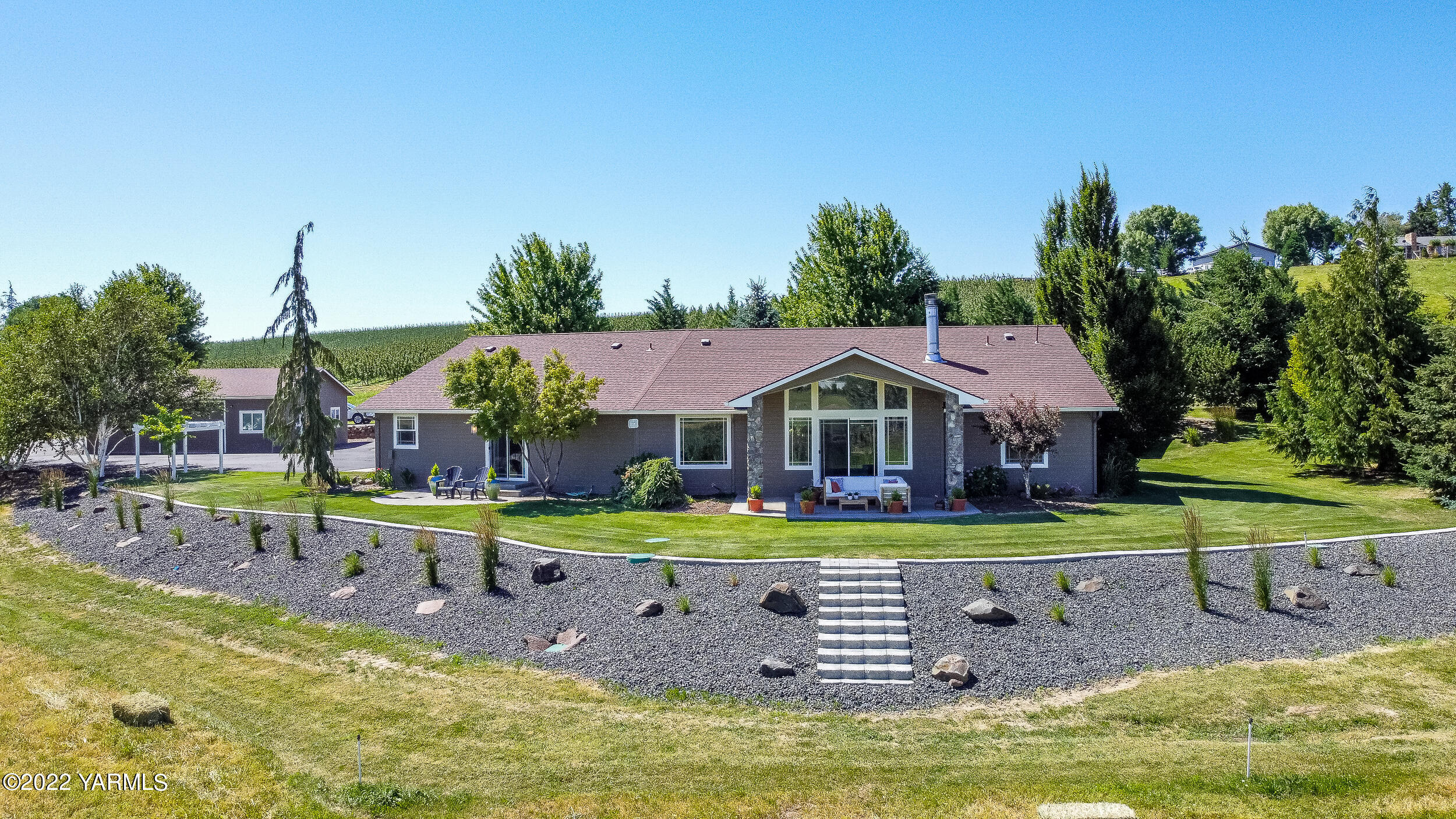 a view of a house with swimming pool and a small yard