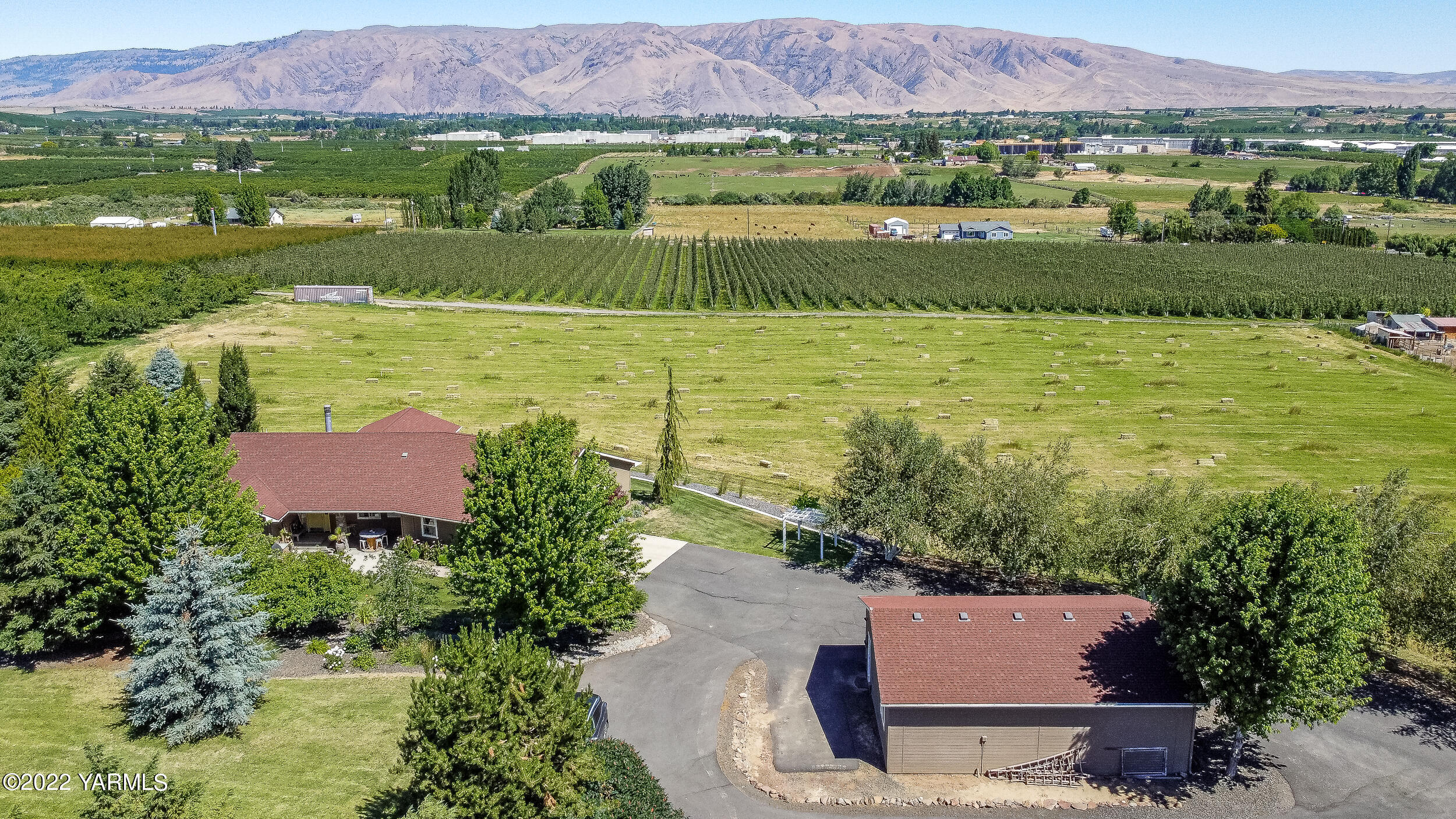 190 Nash Road Tieton, WA 98947 - Photo 5 of 38 an aerial view of a house with a garden and lake view