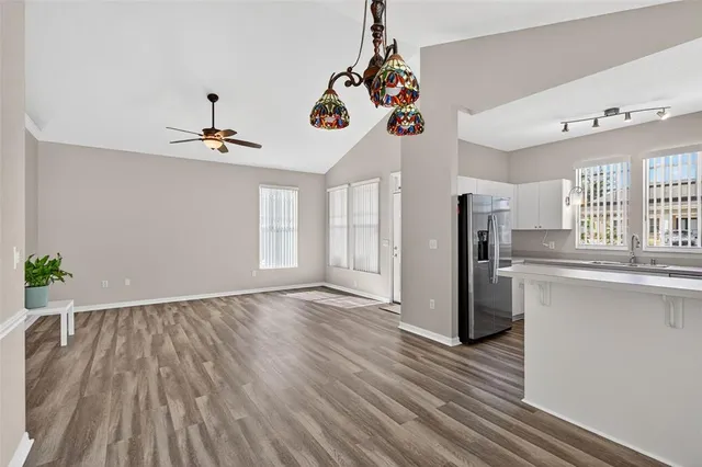 a view of a room with a window and wooden floor